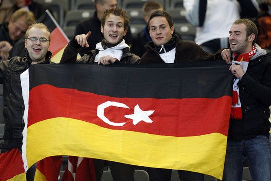 Soccer fans pose before the Euro 2012 qualifying soccer match between Turkey and Germany at the Olympic stadium in Berlin
